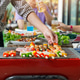 A man grilling pork and barbecue in dinner party. Food, people and family time concept. A man grilling pork and barbecue in dinner party. Food, people and family time concept. - PhotoDune Item for Sale