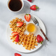 Belgian waffles with fresh strawberries and honey on a white plate on a concrete background Belgian waffles with fresh strawberries and honey on a white plate on a concrete background - PhotoDune Item for Sale