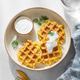 Vegetarian potato waffles with natural yogurt and dill on a plate on a light background with morning Vegetarian potato waffles with natural yogurt and dill on a plate on a light background with morning - PhotoDune Item for Sale