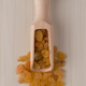 Wooden scoop with golden raisins Wooden scoop with golden raisins - PhotoDune Item for Sale