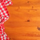 Top view of wooden kitchen table with checkered red and white table cloth Top view of wooden kitchen table with checkered red and white table cloth - PhotoDune Item for Sale