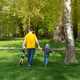 Father and son walking in the park holding hands on a sunny spring day. Family time and leisure Father and son walking in the park holding hands on a sunny spring day. Family time and leisure - PhotoDune Item for Sale