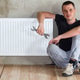 Young handsome plumber sitting on floor with wrench Young handsome plumber sitting on floor with wrench - PhotoDune Item for Sale