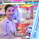 Smiling young Thai Isan businesswoman playing an arcade game and looking away Smiling young Thai Isan businesswoman playing an arcade game and looking away - PhotoDune Item for Sale