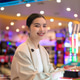 Smiling young Thai Isan businesswoman playing an arcade machine and looking at camera Smiling young Thai Isan businesswoman playing an arcade machine and looking at camera - PhotoDune Item for Sale