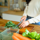 Woman Chopping Fresh Kale on Wooden Cutting Board for Healthy Meal Prep in Modern Kitchen Woman Chopping Fresh Kale on Wooden Cutting Board for Healthy Meal Prep in Modern Kitchen - PhotoDune Item for Sale