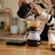 Woman Brewing Pour Over Coffee at Home Kitchen Counter with Gooseneck Kettle and Glass Carafe Woman Brewing Pour Over Coffee at Home Kitchen Counter with Gooseneck Kettle and Glass Carafe - PhotoDune Item for Sale