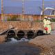 Two workers in yellow suits inspect a wastewater outfall Two workers in yellow suits inspect a wastewater outfall - PhotoDune Item for Sale