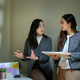 Two Businesswomen Discussing Data Presentation with Charts on Screen and Projector in Modern Office Two Businesswomen Discussing Data Presentation with Charts on Screen and Projector in Modern Office - PhotoDune Item for Sale