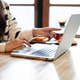 Woman Working on Laptop at Home with Coffee and Snacks on Wooden Table in Cozy Domestic Setting Woman Working on Laptop at Home with Coffee and Snacks on Wooden Table in Cozy Domestic Setting - PhotoDune Item for Sale