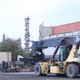 Large container handling machine parked at cargo shipping terminal with industrial refinery backgrou Large container handling machine parked at cargo shipping terminal with industrial refinery backgrou - PhotoDune Item for Sale