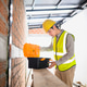Young Asian Engineer Opening Toolbox at Construction Site Wearing Yellow Hard Hat and Safety Vest Young Asian Engineer Opening Toolbox at Construction Site Wearing Yellow Hard Hat and Safety Vest - PhotoDune Item for Sale