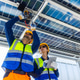 Solar Technicians Installing Microinverter Under Panels Solar Technicians Installing Microinverter Under Panels - PhotoDune Item for Sale