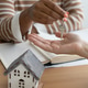 Close-up of happy woman realtor or property owner handing over key to house. Close-up of happy woman realtor or property owner handing over key to house. - PhotoDune Item for Sale