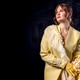 High fashion photography: a beautiful, elegant woman in a yellow pantsuit posing against a dark back High fashion photography: a beautiful, elegant woman in a yellow pantsuit posing against a dark back - PhotoDune Item for Sale
