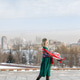 A young woman in a military dress and cap holds a beautiful fluttering scarf in a city square on May A young woman in a military dress and cap holds a beautiful fluttering scarf in a city square on May - PhotoDune Item for Sale
