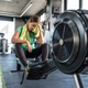 A woman sits down in the gym, taking a short break after an intense workout. A woman sits down in the gym, taking a short break after an intense workout. - PhotoDune Item for Sale