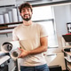 A print shop worker stands confidently in the production area, surrounded by printing equipment and A print shop worker stands confidently in the production area, surrounded by printing equipment and - PhotoDune Item for Sale