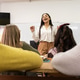 A small group of students is in their elementary classroom while a mixed-race teacher guides them th A small group of students is in their elementary classroom while a mixed-race teacher guides them th - PhotoDune Item for Sale