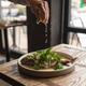 Chef squeezing lemon over grilled seabass dish Chef squeezing lemon over grilled seabass dish - PhotoDune Item for Sale