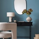 Interior design warm and cozy living room with mirror, black desk, gray armchair, vase with flowers, Interior design warm and cozy living room with mirror, black desk, gray armchair, vase with flowers, - PhotoDune Item for Sale