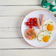 Fried eggs with sausage, cherry tomatoes and buckwheat bread with salmon fish Fried eggs with sausage, cherry tomatoes and buckwheat bread with salmon fish - PhotoDune Item for Sale