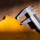 Metal Caliper Measuring Tool on Yellow and Brown Raw Leather Surface, Leather Craft Workshop Close-U Metal Caliper Measuring Tool on Yellow and Brown Raw Leather Surface, Leather Craft Workshop Close-U - PhotoDune Item for Sale