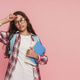Tired schoolgirl with backpack and glasses holding books and showing exhausted gesture Tired schoolgirl with backpack and glasses holding books and showing exhausted gesture - PhotoDune Item for Sale
