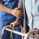 Close up of senior woman walking with walker while nurse helps her at home, caregiver supporting Close up of senior woman walking with walker while nurse helps her at home, caregiver supporting - PhotoDune Item for Sale
