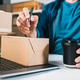 Person Processing Online Orders with Laptop and Shipping Package in Home Fulfillment Workspace Person Processing Online Orders with Laptop and Shipping Package in Home Fulfillment Workspace - PhotoDune Item for Sale