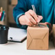 Person Labeling Shipping Box During E-commerce Order Fulfillment Process Person Labeling Shipping Box During E-commerce Order Fulfillment Process - PhotoDune Item for Sale