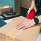 Person Sealing Shipping Box with Packing Tape for E-commerce Order Fulfillment Process Person Sealing Shipping Box with Packing Tape for E-commerce Order Fulfillment Process - PhotoDune Item for Sale