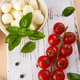 Ingredients for caprese salad: cherry tomatoes on a wooden board, mozzarella cheese, basil. Ingredients for caprese salad: cherry tomatoes on a wooden board, mozzarella cheese, basil. - PhotoDune Item for Sale