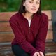 Happy woman seated outdoors in burgundy top, intimate close up with quiet mood and natural beauty Happy woman seated outdoors in burgundy top, intimate close up with quiet mood and natural beauty - PhotoDune Item for Sale