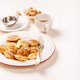 Dutch small pancakes poffertjes served with butter, sugar cubes, and coffee on a white background Dutch small pancakes poffertjes served with butter, sugar cubes, and coffee on a white background - PhotoDune Item for Sale