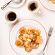 Dutch small pancakes poffertjes served on white plates with coffee and powdered sugar on top Dutch small pancakes poffertjes served on white plates with coffee and powdered sugar on top - PhotoDune Item for Sale