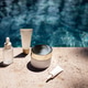 Skincare products arranged on a stone surface beside a swimming pool, featuring a serum, cream, and Skincare products arranged on a stone surface beside a swimming pool, featuring a serum, cream, and - PhotoDune Item for Sale