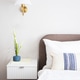 Modern bedroom interior featuring a stylish bed with white linens, decorative pillows, a bedside tab Modern bedroom interior featuring a stylish bed with white linens, decorative pillows, a bedside tab - PhotoDune Item for Sale