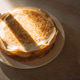 Stack of golden brown pancakes on a white plate illuminated by natural light with a shadow cast acro Stack of golden brown pancakes on a white plate illuminated by natural light with a shadow cast acro - PhotoDune Item for Sale