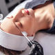 Female skincare specialist applying facial treatment to a woman lying on a treatment table, showcasi Female skincare specialist applying facial treatment to a woman lying on a treatment table, showcasi - PhotoDune Item for Sale