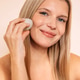 Blonde woman applying makeup with a beauty sponge, showcasing a natural look, in a soft-lit environm Blonde woman applying makeup with a beauty sponge, showcasing a natural look, in a soft-lit environm - PhotoDune Item for Sale