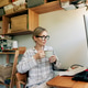 Modern business woman in the morning at home in pajamas with a mug of coffee in the interior of the Modern business woman in the morning at home in pajamas with a mug of coffee in the interior of the - PhotoDune Item for Sale