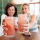 Two friends cheer with refreshing drinks, smiling and enjoying brunch moment together. Two friends cheer with refreshing drinks, smiling and enjoying brunch moment together. - PhotoDune Item for Sale