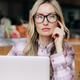 Pensive business woman working on a laptop in a cafe. Pensive business woman working on a laptop in a cafe. - PhotoDune Item for Sale