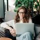 An attractive red-haired woman is sitting in a coffee shop and working using a laptop. An attractive red-haired woman is sitting in a coffee shop and working using a laptop. - PhotoDune Item for Sale
