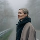 Woman in a coat on a rural road in foggy weather. Psychological relaxation in the surrounding area. Woman in a coat on a rural road in foggy weather. Psychological relaxation in the surrounding area. - PhotoDune Item for Sale