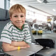 Smiling boy sit plane seat inside aviation museum surrounded historic aircraft aerospace exhibits. C Smiling boy sit plane seat inside aviation museum surrounded historic aircraft aerospace exhibits. C - PhotoDune Item for Sale