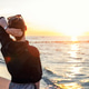 Back view young adult woman dreamy looking sunset horizon on sandy beach shore warm evening sunset l Back view young adult woman dreamy looking sunset horizon on sandy beach shore warm evening sunset l - PhotoDune Item for Sale