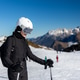 Portrait young adult happy smiling woman skier wear black outfit overall stand snowy slope raised ha Portrait young adult happy smiling woman skier wear black outfit overall stand snowy slope raised ha - PhotoDune Item for Sale