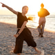 Joyful teen child dancing barefoot sandy beach during warm sunset, expressing freedom, movement, ene Joyful teen child dancing barefoot sandy beach during warm sunset, expressing freedom, movement, ene - PhotoDune Item for Sale